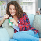 Illustration for article titled Woman’s Guilty Pleasure Just Sitting On Couch With Pint Of Ice Cream And Watching Man Shackled To Radiator Plead For Mercy